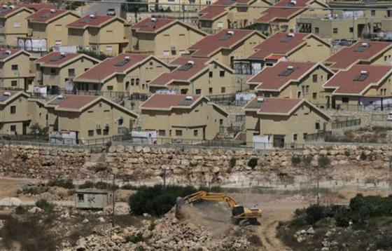 Israeli earth-moving equipment works in the Jewish settlement of Kiryat Netafim, near the West Bank village of Salfit. Top Palestinian official Saeb Erekat said Wednesdaythat Palestinians will ask the U.N. Security Council in the coming days to condemn Israeli settlement construction. 